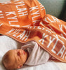 At The Knit Studio we knit our personalised baby blankets in 100% Organic Cotton. This Cot sized blanket is Tangerine and White, the perfect keepsake. There are 25 colours and 7 fonts plus over 50 graphic symbols to choose from. Sustainably, each blanket is individually knitted to order. This custom blanket is personalized with the name of your choice. Australian Made and owned, we provide free shipping worldwide. Design your own named blanket. Perfect for baby’s birthday or Car seat, Pram and toddler bed.