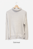 Merino wool jumper in Oatmeal featuring a funnel rolled neckline and ribbed sleeves