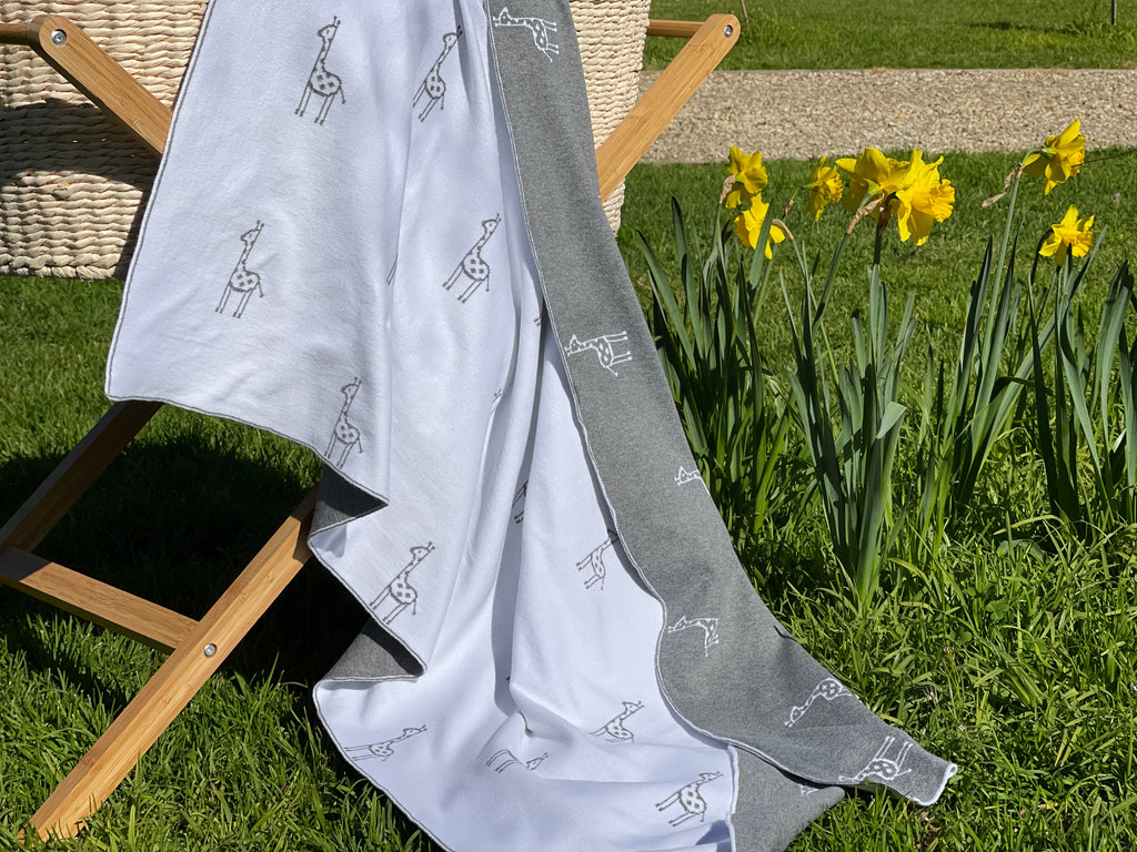The Knit Studio. Fine knit Giraffe blanket. Choose from a selection of colours. This soft pure organic cotton cot sized blanket is perfect for pram and bassinet to. Knitted in our studio on the Mornington Peninsula in Australia. Quality guaranteed. Pale Grey and White.