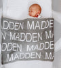 At The Knit Studio we knit our personalised baby blankets in 100% Organic Cotton. Bassinet  sized Madden’s blanket is Mid Grey and white. There are 25 colours and 7 fonts plus over 50 graphic symbols to choose from. Sustainably, each blanket is individually knitted to order. This custom blanket is personalized with the name of your choice. Australian Made and owned, we provide free shipping worldwide. Design your own named blanket and we’ll provide a quality guarantee.