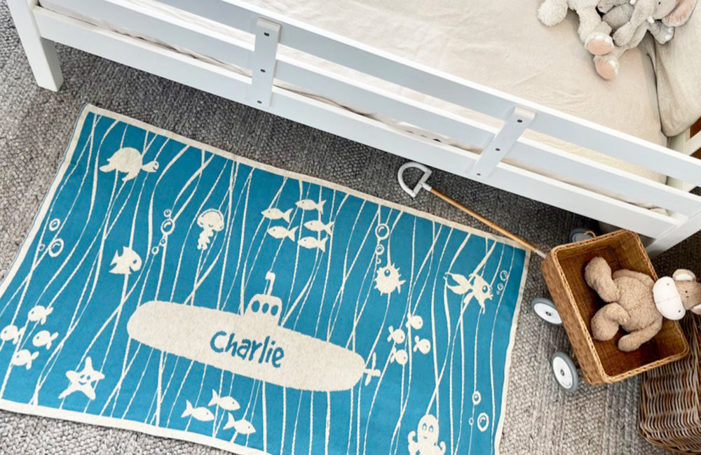 The Knit Studio personalised baby blankets are knitted in the finest quality Organic Cotton. This Under the Sea Cot sized blanket in Aqua and Oatmeal is Designed by us from our Designer Collection. Soft and luxurious, the perfect keepsake. Choose from our preselected colour combos. Sustainably, each blanket is individually knitted to order. This custom blanket is personalized with the name of your choice. Australian Made and owned, we provide free shipping worldwide. Choice of size. 