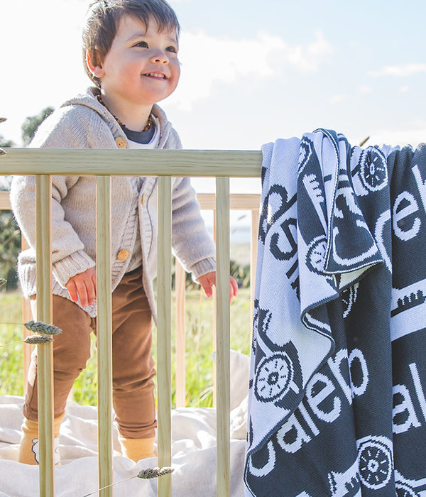 At The Knit Studio we knit our personalised baby blankets in 100% Organic Cotton. This Cot sized blanket is Navy Blue and Pale Blue, with a racing car symbol. There are 25 colours and 7 fonts plus over 50 graphic symbols to choose from. Sustainably, each blanket is individually knitted to order. This custom blanket is personalized with the name of your choice. Australian Made and owned, we provide free shipping worldwide. Design your own named blanket and we’ll provide a quality guarantee.